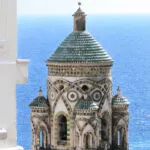the bell tower of cathedral in Amalfi - Italy - against blue sea