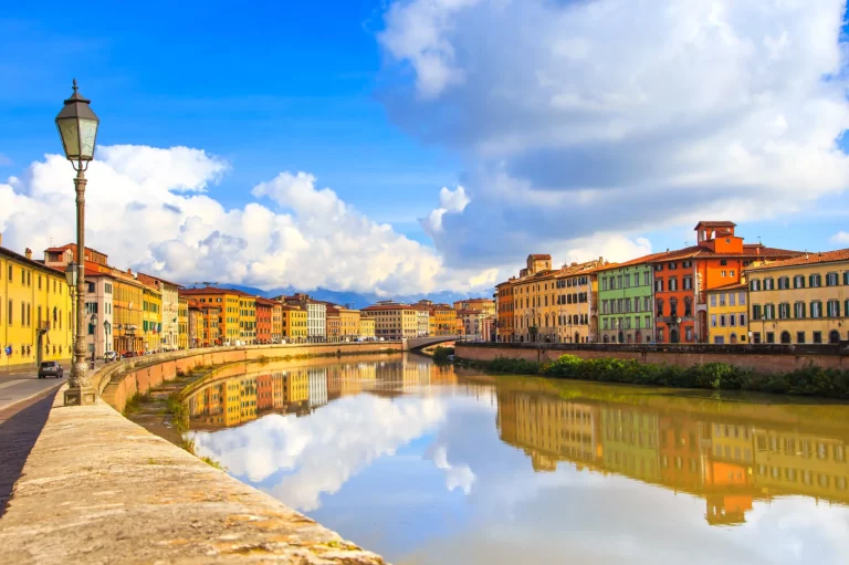 Pisa, Arno river, lamp and buildings reflection. Lungarno view.