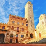 Picturesque View of famous Piazza del Duomo in San Gimignano at sunset, Tuscany, Italy