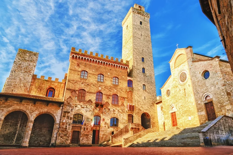Picturesque View of famous Piazza del Duomo in San Gimignano at sunset, Tuscany, Italy
