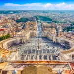 Famous Saint Peter's Square in Vatican and aerial view of the Rome city during sunny day.